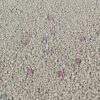 Close-up of regular dust-free bentonite cat litter with colorful odor control beads mixed throughout the granules.