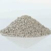 Pile of granular bentonite cat litter, highlighting its even granule size and superior absorption.