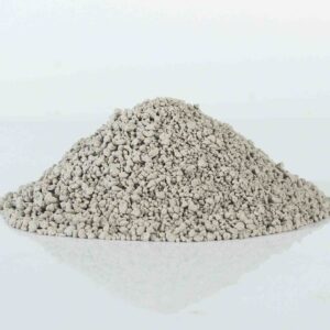 Pile of granular bentonite cat litter, highlighting its even granule size and superior absorption.