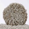 Compact clump of flushable spherical bentonite cat litter, showcasing its effective clumping and flushability.