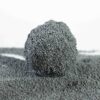 Compact clump of carbon granular bentonite cat litter, showcasing its effective clumping ability and fine texture.