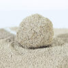 Close-up of hamster spherical cat litter granules forming firm clumps, highlighting absorbency and odor control.