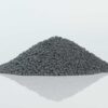 Pile of carbon spherical bentonite cat litter, showcasing its dark color and uniform spherical granules.